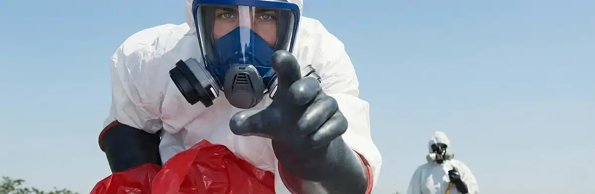 sewage clean up technician wearing protective gear handling biohazard materials in Denver, CO