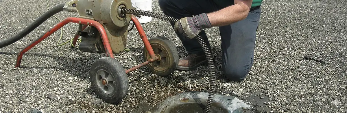 sewer rodding technician actively removing blockages from a sewer line in Denver, CO