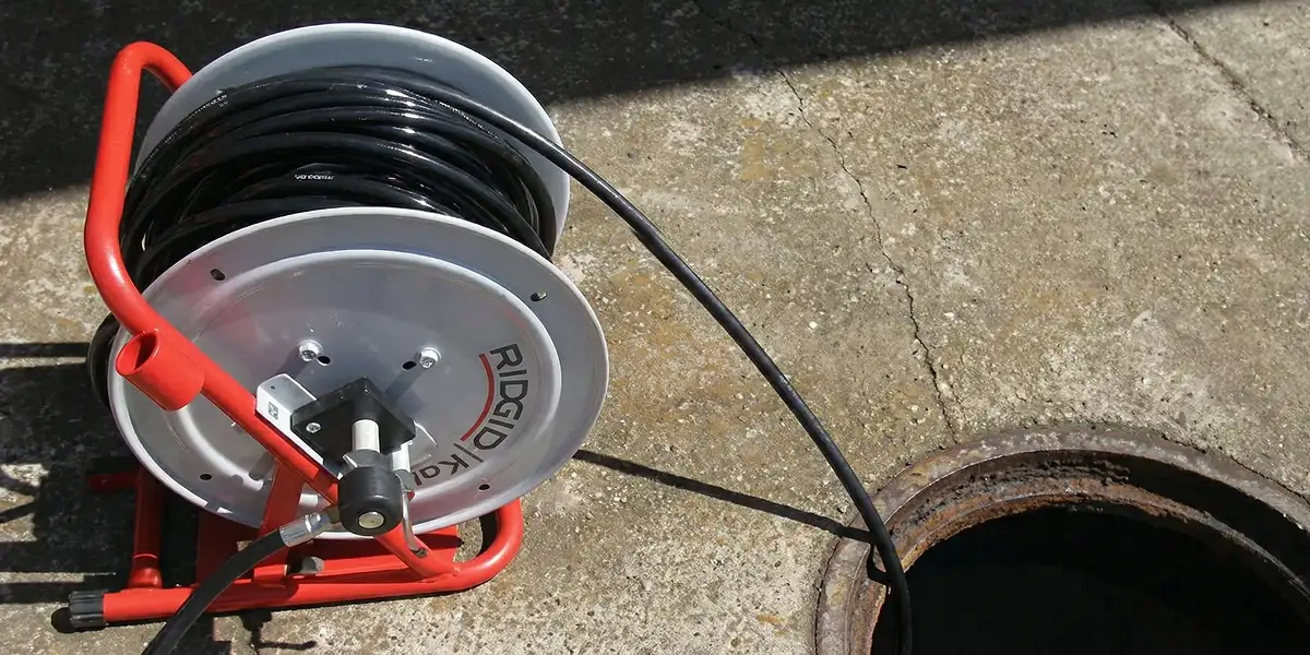 sewer rodding equipment prepared to clear clogged sewer lines in Denver, CO